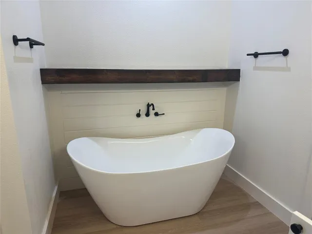 a white tub sitting next to a window