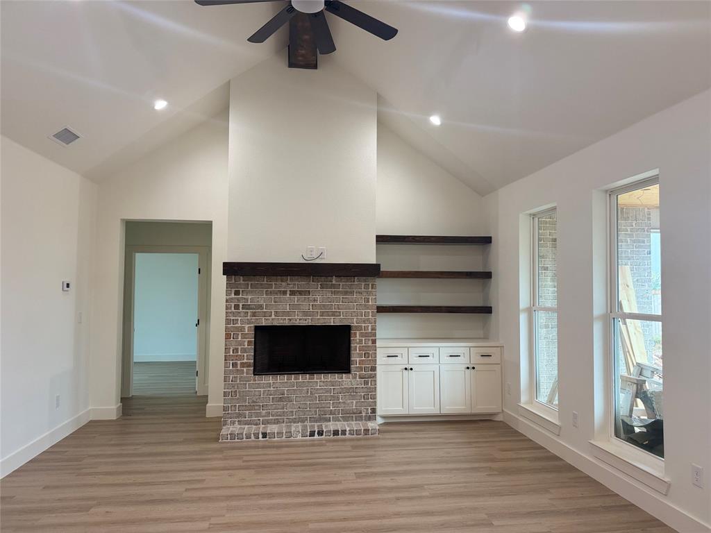 150 Ridge Road Tuscola, TX 79562 - Photo 2 of 12 a view of an empty room with a fireplace and a window