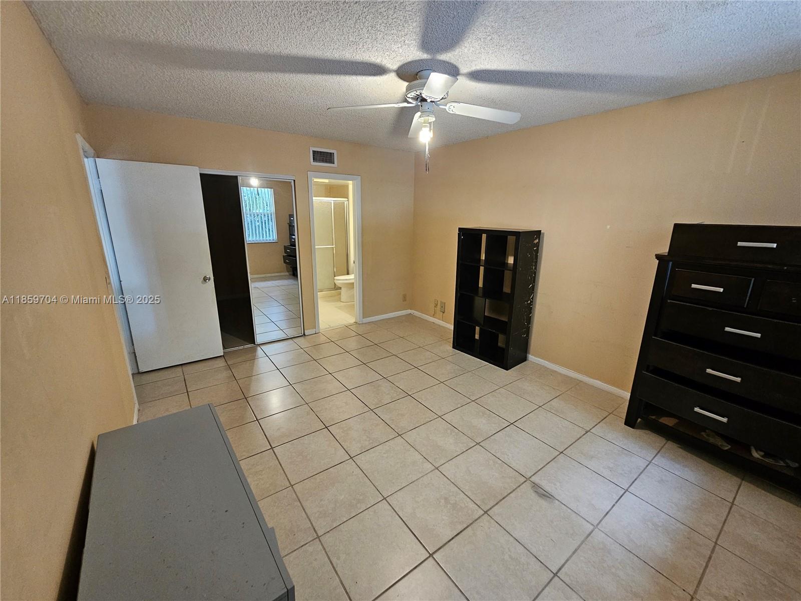 8701 Wiles Road, Unit 305 Coral Springs, FL 33067 - Photo 11 of 17 a view of an empty room with closet and cabinet