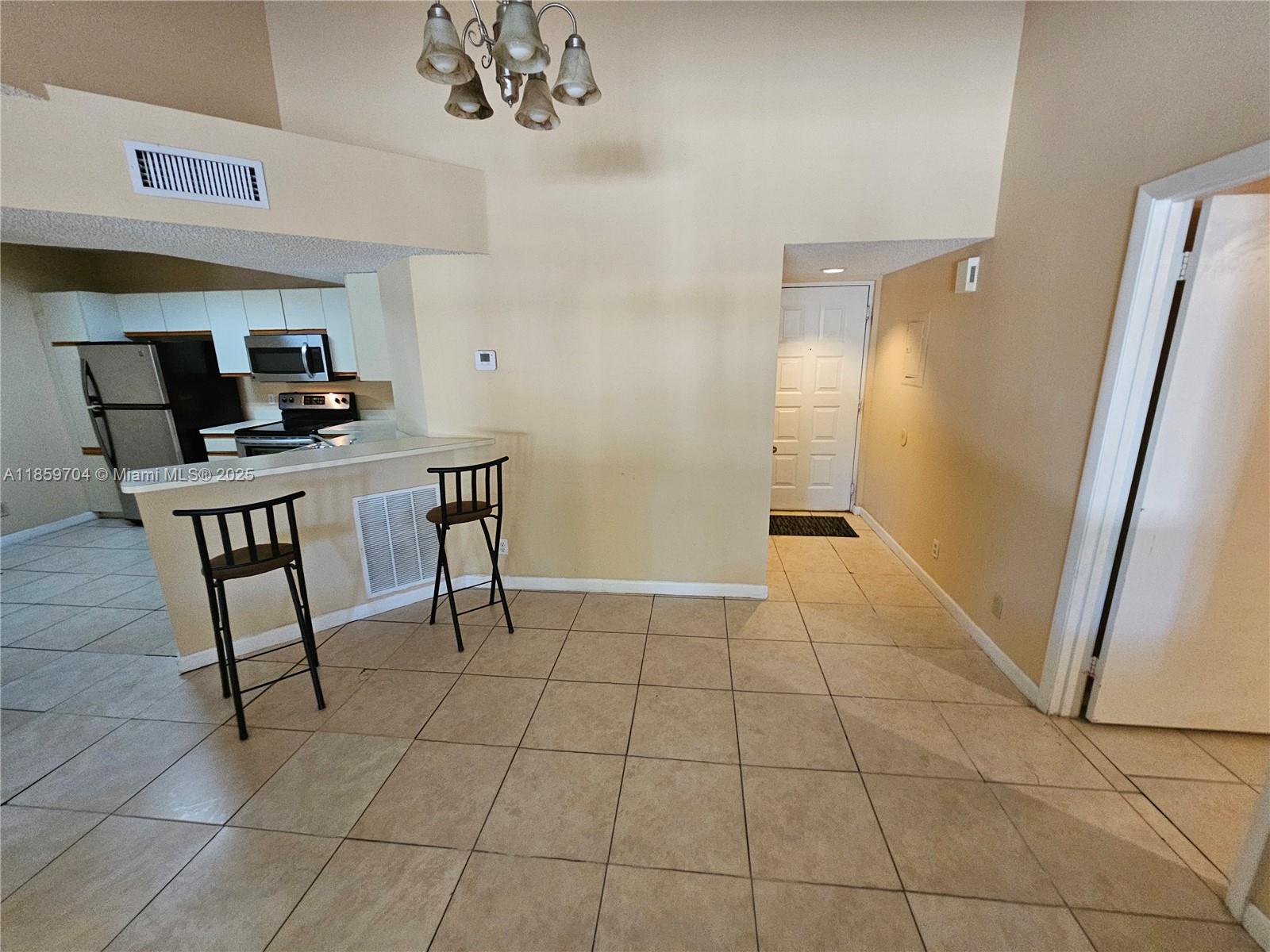 8701 Wiles Road, Unit 305 Coral Springs, FL 33067 - Photo 5 of 17 a view of a workspace with furniture