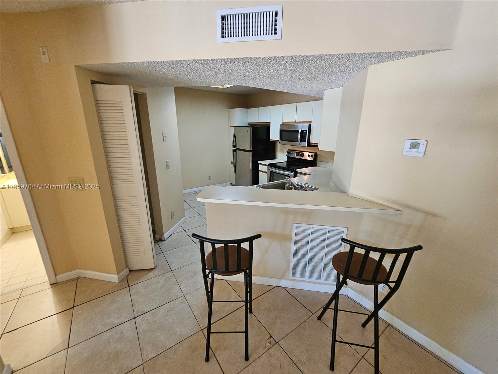 8701 Wiles Road, Unit 305 Coral Springs, FL 33067 - Photo 6 of 17 a view of a dining room with furniture and window