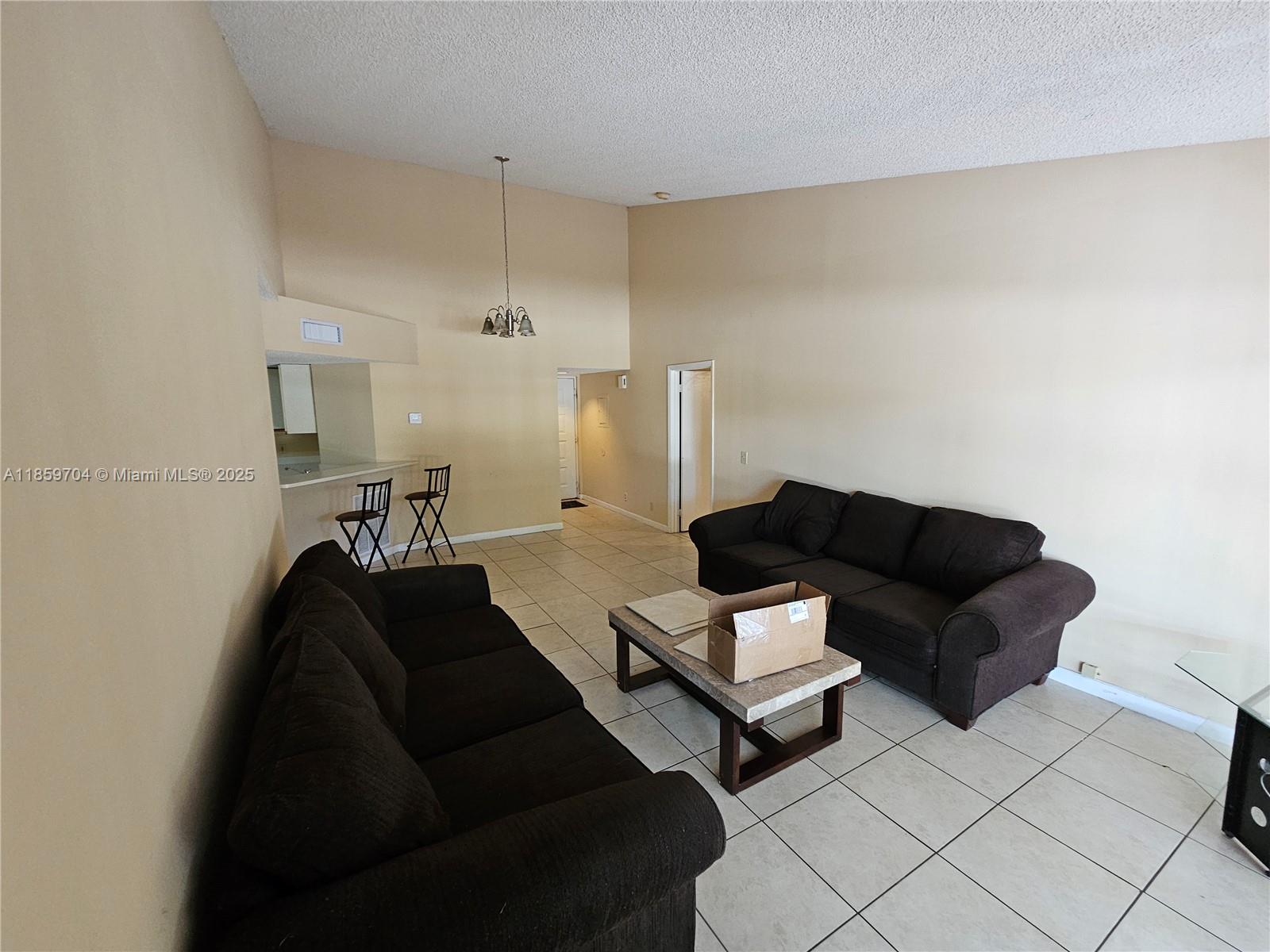 8701 Wiles Road, Unit 305 Coral Springs, FL 33067 - Photo 8 of 17 a living room with couches and a coffee table