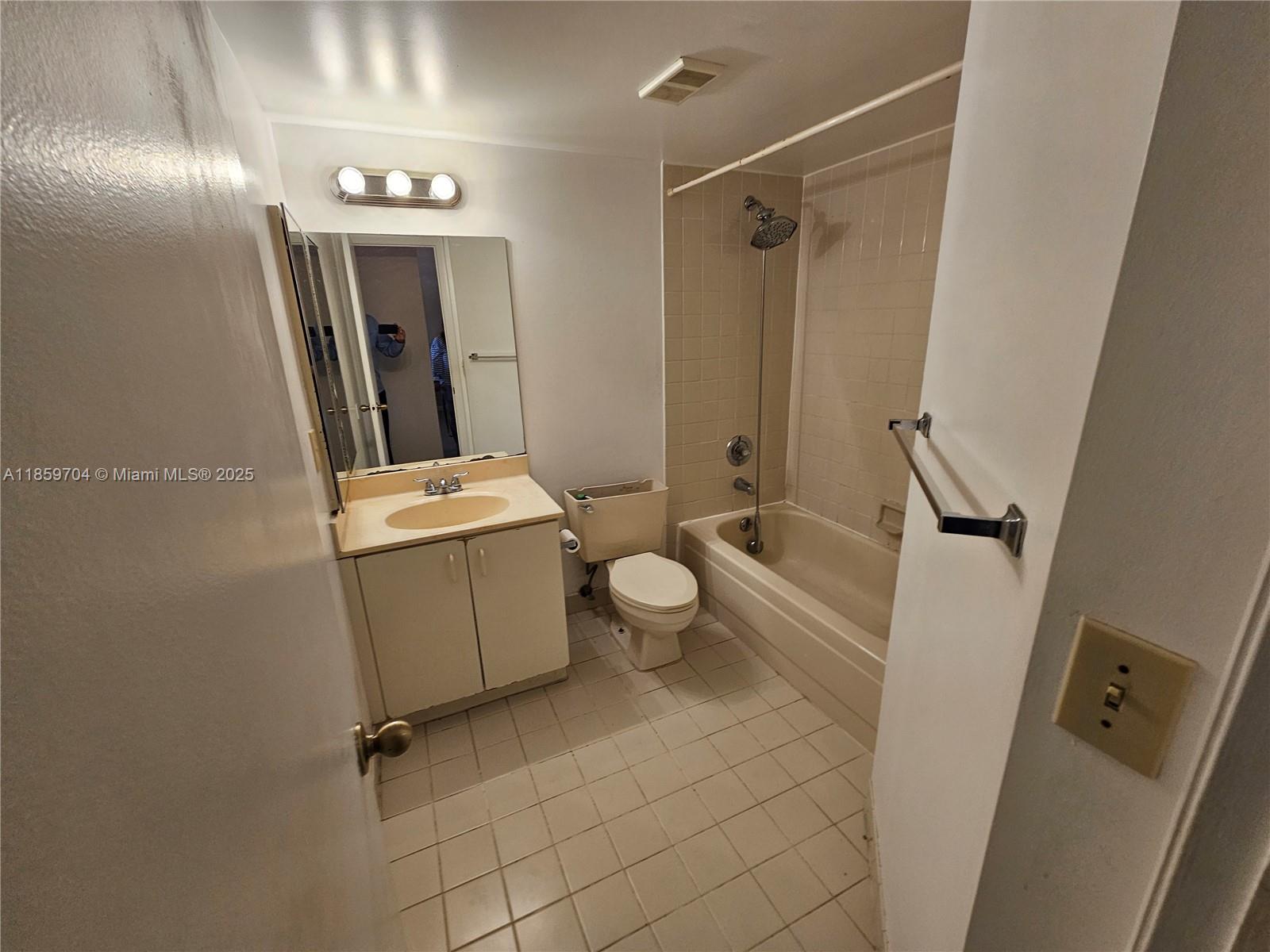 8701 Wiles Road, Unit 305 Coral Springs, FL 33067 - Photo 10 of 17 a bathroom with a sink a toilet and shower