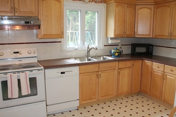 16 Freemont Street Lexington, MA 02421 - Photo 8 of 25 a kitchen with stainless steel appliances granite countertop a sink stove and refrigerator