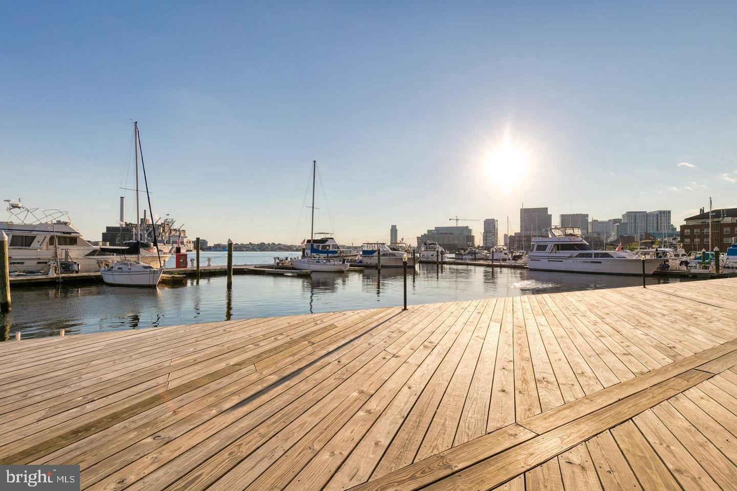1000 Fell Street, Unit 606 Baltimore, MD 21231 - Photo 47 of 56 Sunlit marina with serene waters.