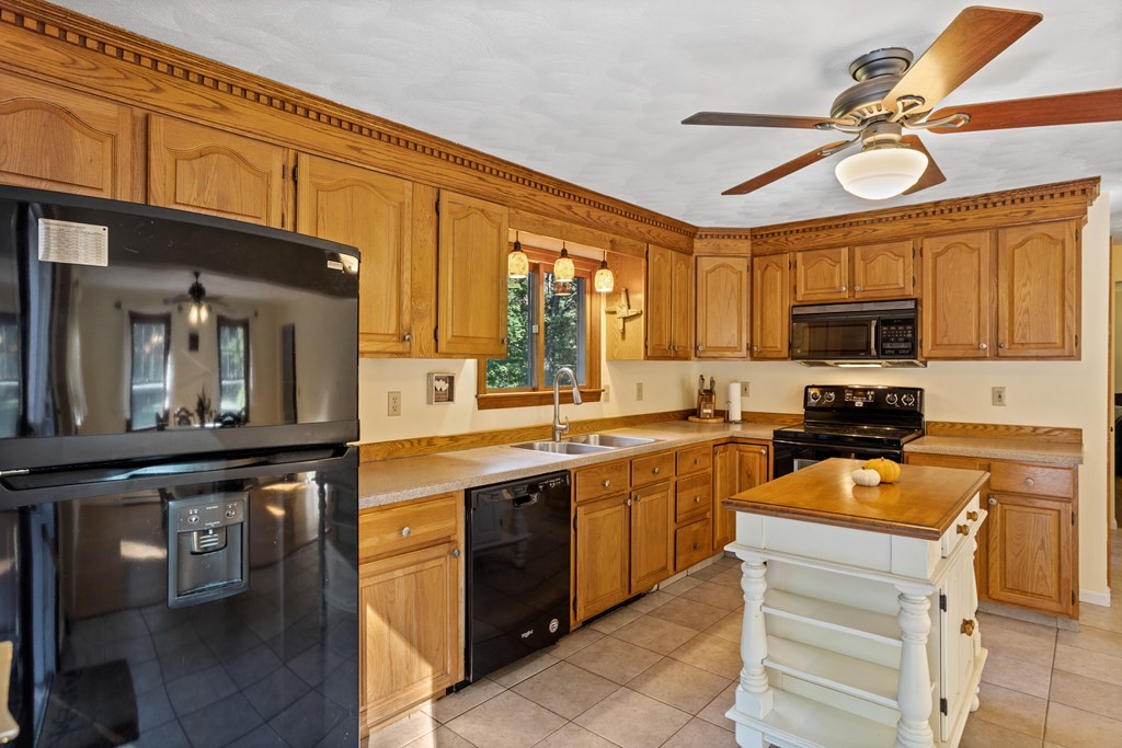 10 Pheasant Ridge Road Townsend, MA 01469 - Photo 22 of 40 a kitchen with stainless steel appliances granite countertop a stove and cabinets