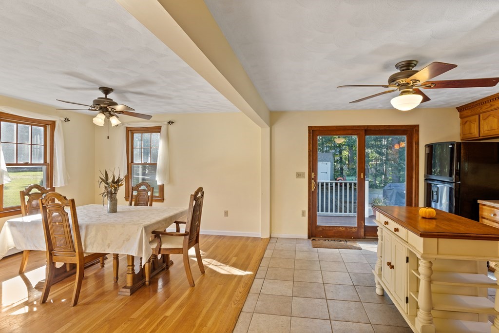 10 Pheasant Ridge Road Townsend, MA 01469 - Photo 24 of 40 a view of a dining room with furniture a chandelier and large windows