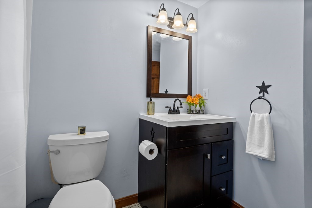 10 Pheasant Ridge Road Townsend, MA 01469 - Photo 29 of 40 a bathroom with a toilet sink and mirror
