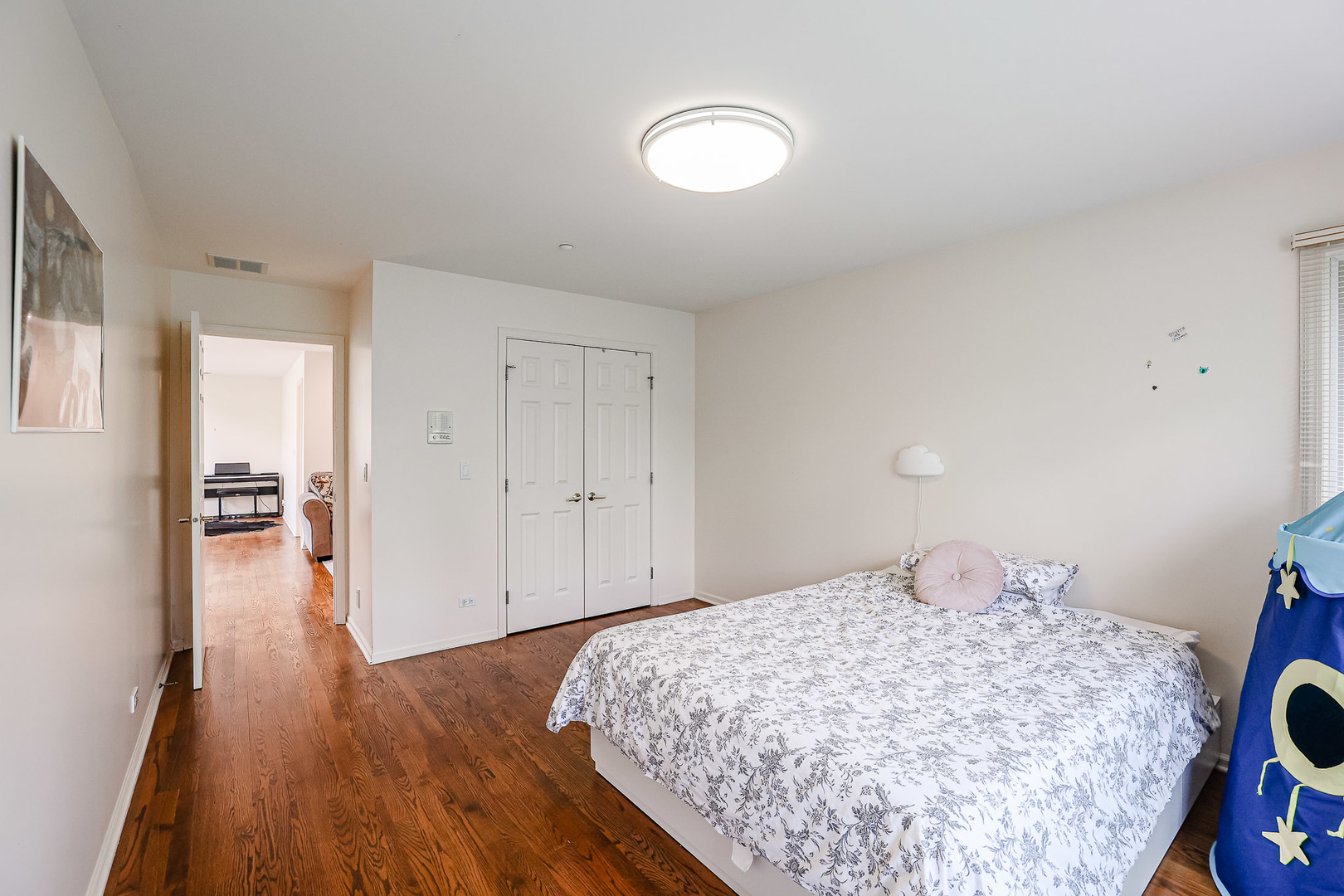 16 Ridge Road Highland Park, IL 60035 - Photo 28 of 41 a bedroom with a bed and a chandelier