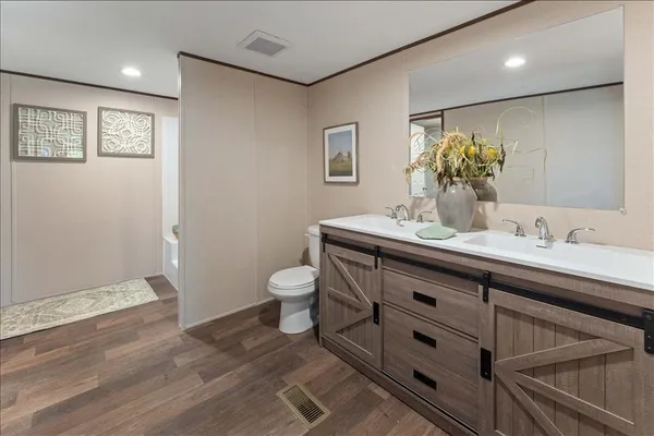 a bathroom with a sink mirror and toilet