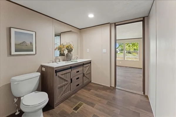 a bathroom with a toilet sink and mirror