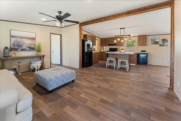 a bedroom with a bed a chandelier and flat screen tv