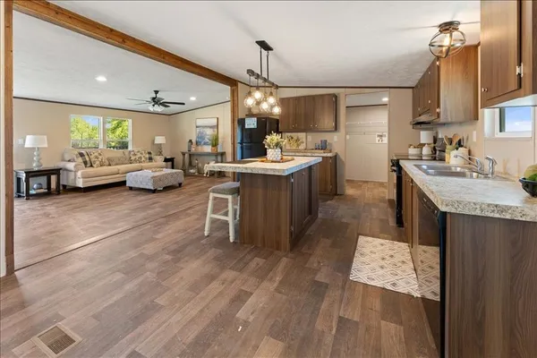 a kitchen with sink refrigerator and cabinets
