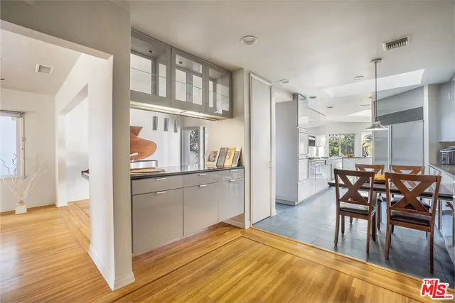 a kitchen with stainless steel appliances granite countertop a refrigerator and microwave