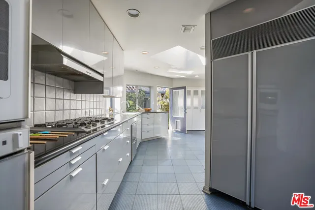 a kitchen with stainless steel appliances granite countertop a stove and a refrigerator