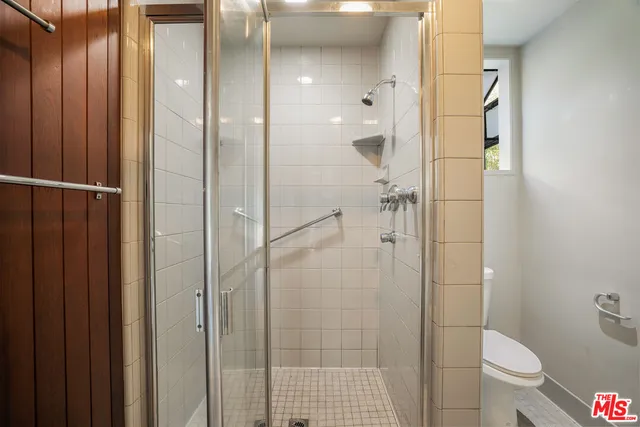 a bathroom with a shower and a toilet