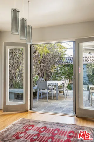 a view of a dining room with furniture wooden floor and a floor to ceiling window