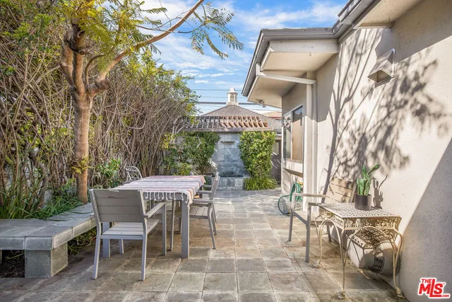 a view of a patio with table and chairs and potted plants