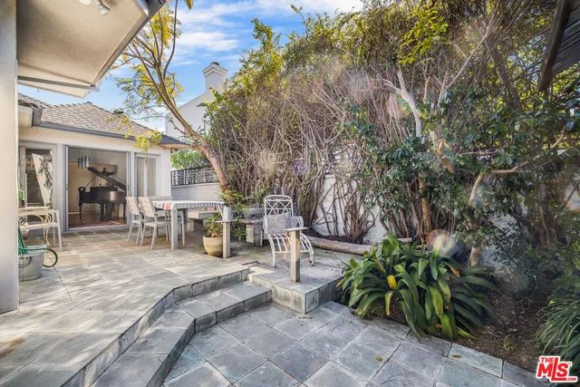 a view of a house with backyard and sitting area