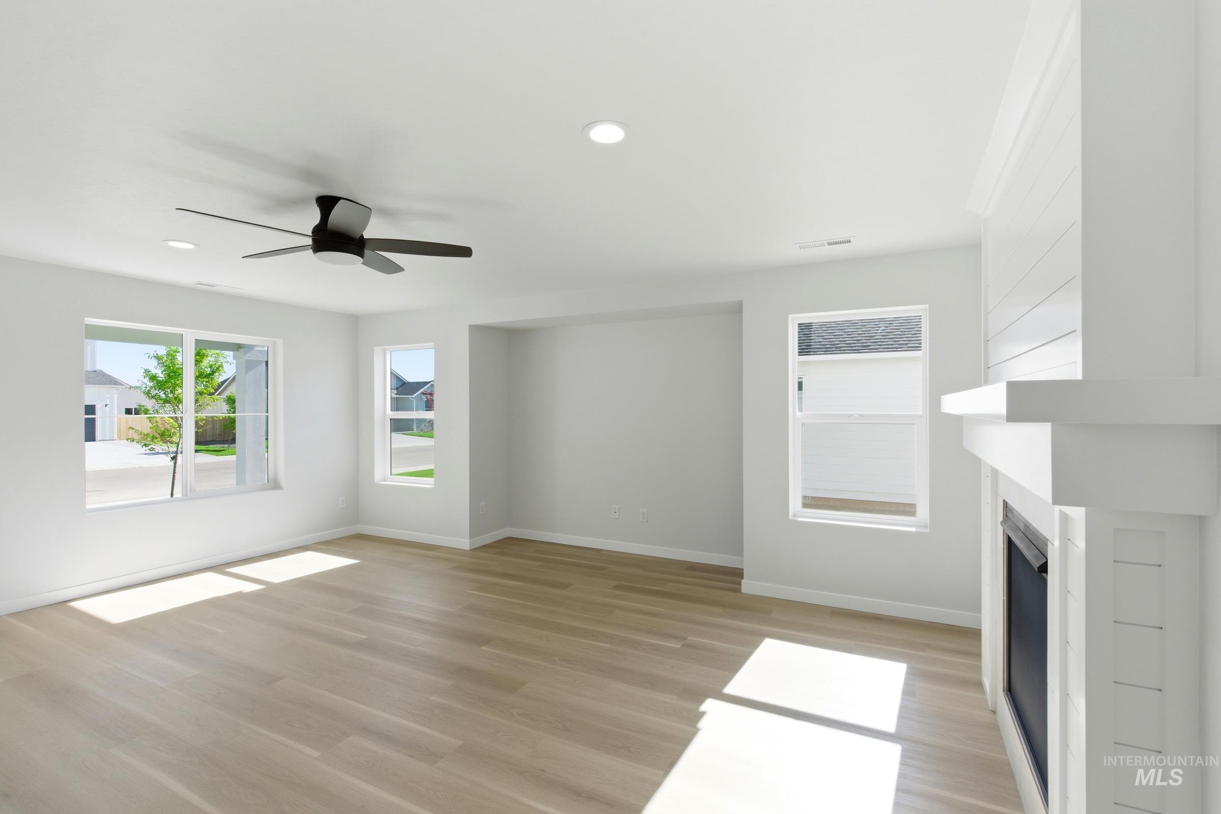 13677 Redway Court Caldwell, ID 83607 - Photo 15 of 35 Spacious room featuring light wood-finish flooring, a contemporary ceiling fan, and recessed lighting