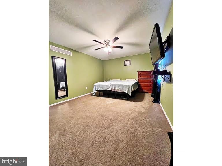 402 Pheasant Circle Bear, DE 19701 - Photo 13 of 17 a bedroom with a bed and a chandelier