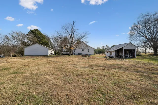 a large house with a large tree in front of it