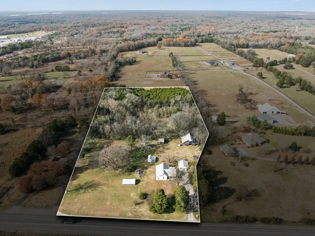 an aerial view of a houses with a yard