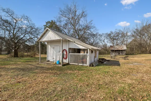 a view of a house with a yard covered in snow