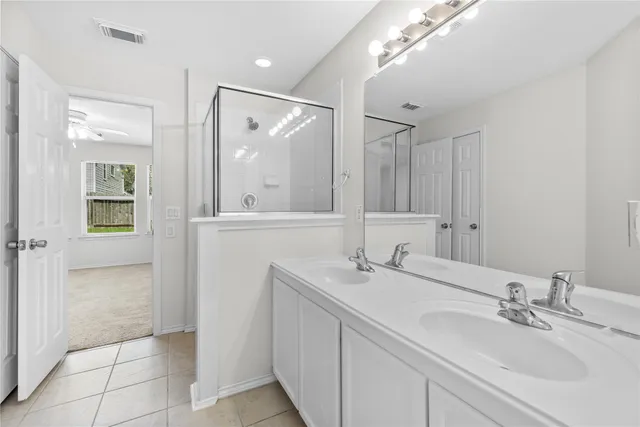 a bathroom with a double vanity sink mirror and double