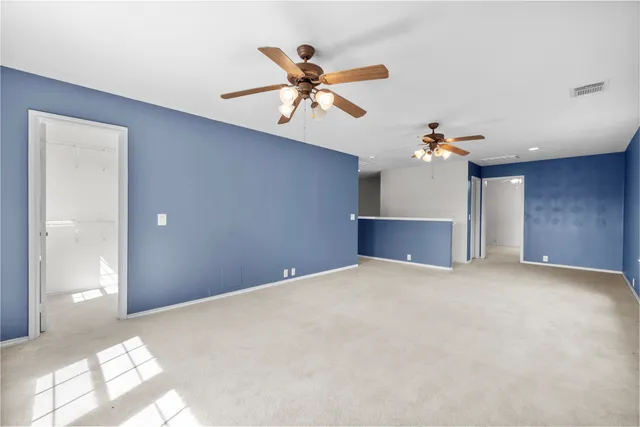 a view of a livingroom with a ceiling fan and window