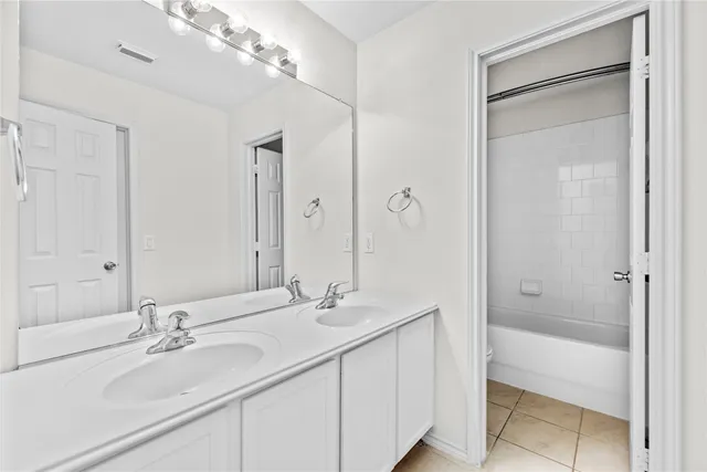 a bathroom with a double vanity sink and a mirror