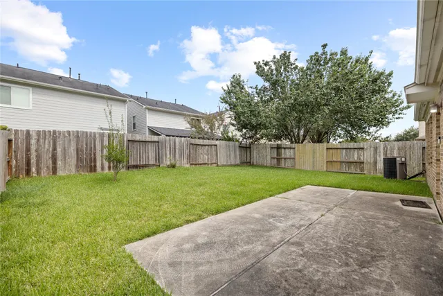 a view of a backyard with a garden and entertaining space