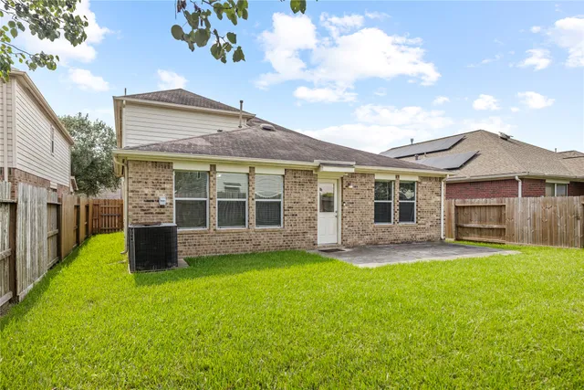 a front view of a house with a garden and yard
