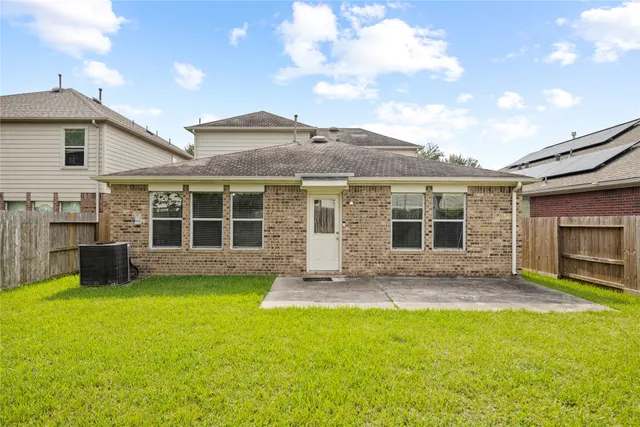 a front view of a house with a garden and yard