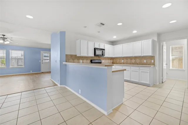 a kitchen with stainless steel appliances granite countertop a refrigerator sink and cabinets