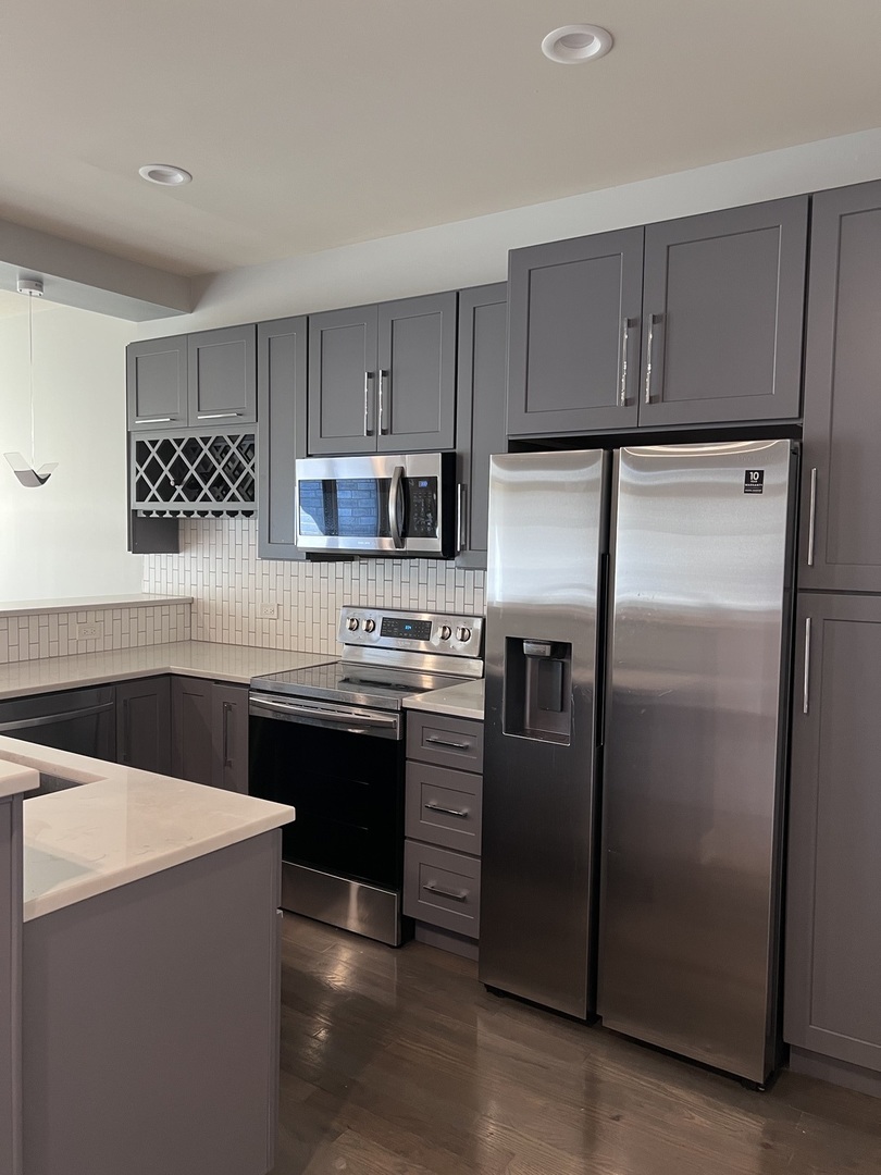 1208 East 64th Street, Unit 3D Chicago, IL 60637 - Photo 4 of 20 a kitchen with a refrigerator sink and cabinets