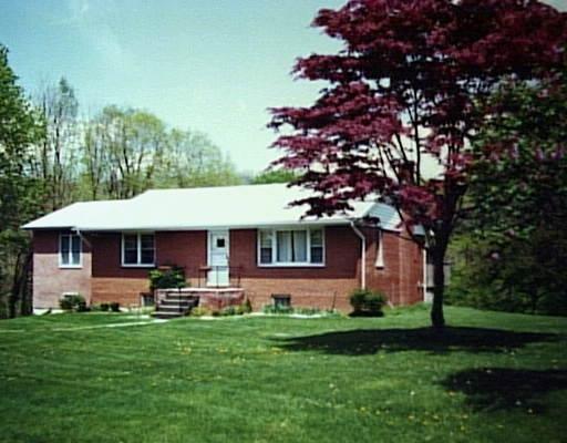42 Hobby Drive Ridgefield, CT 06877 - Photo 1 of 1 a front view of house with yard and green space