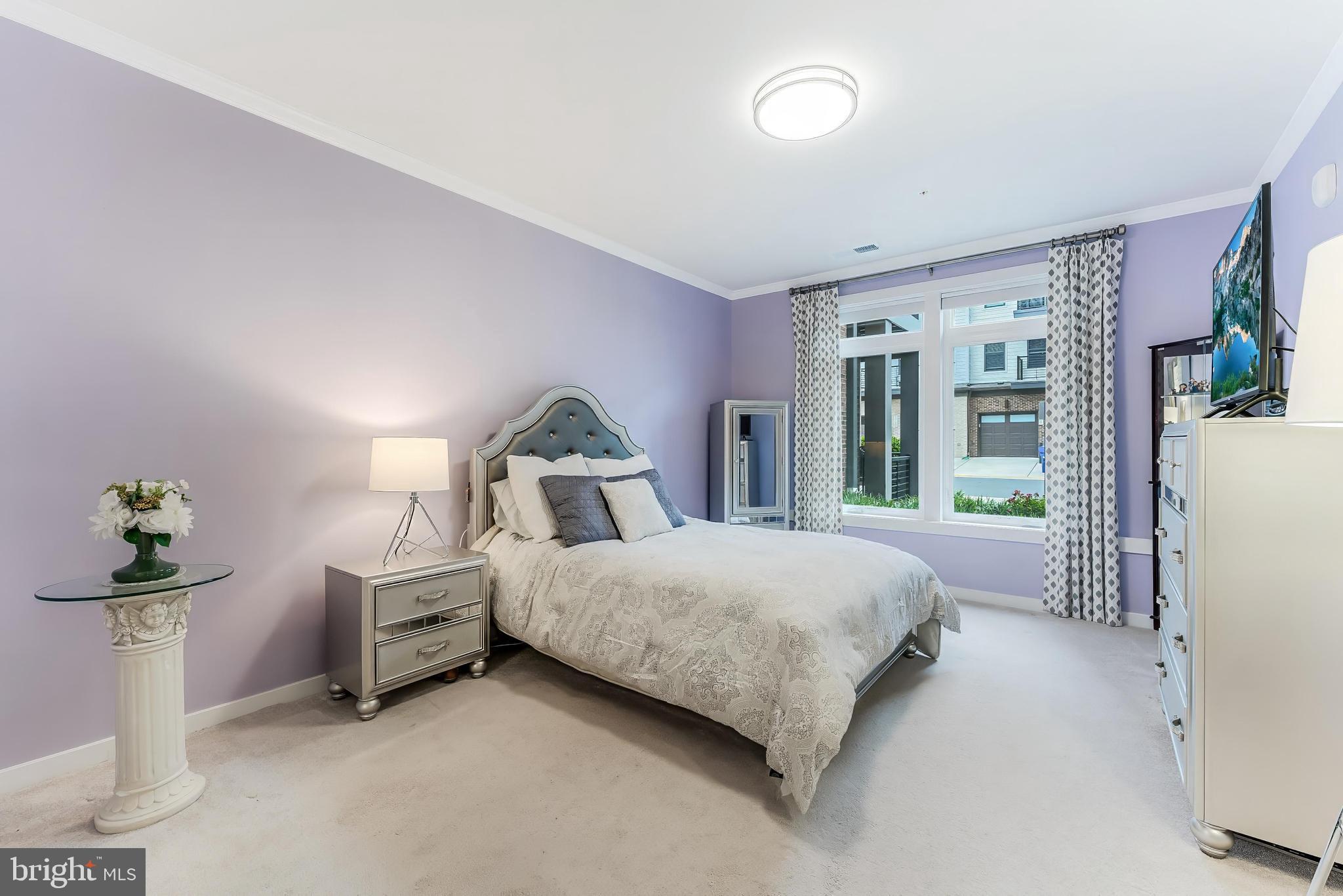 1675 Bandit Loop, Unit 105B Reston, VA 20190 - Photo 18 of 27 a bedroom with bed and a window