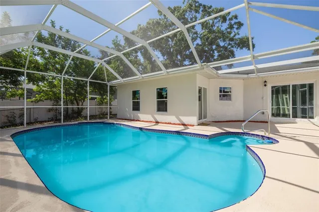 a view of a swimming pool with potted plants