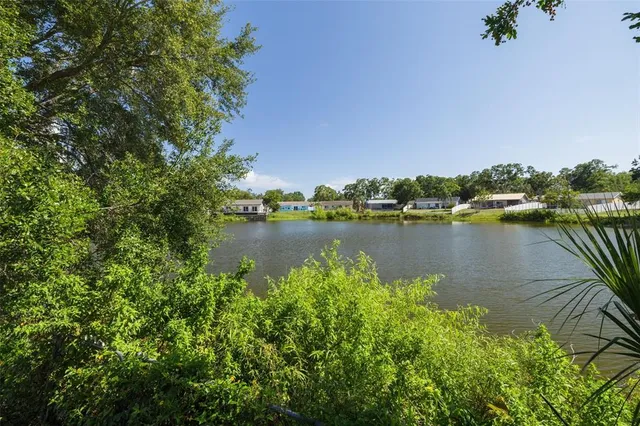 an aerial view of a houses with a lake view