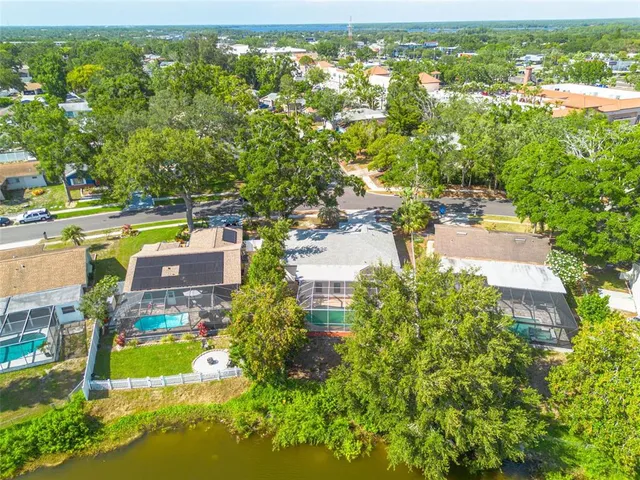 an aerial view of residential houses with outdoor space and swimming pool