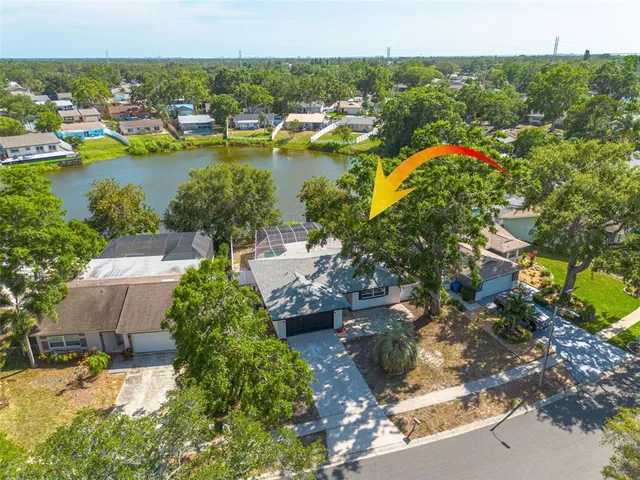 an aerial view of residential houses with outdoor space and swimming pool