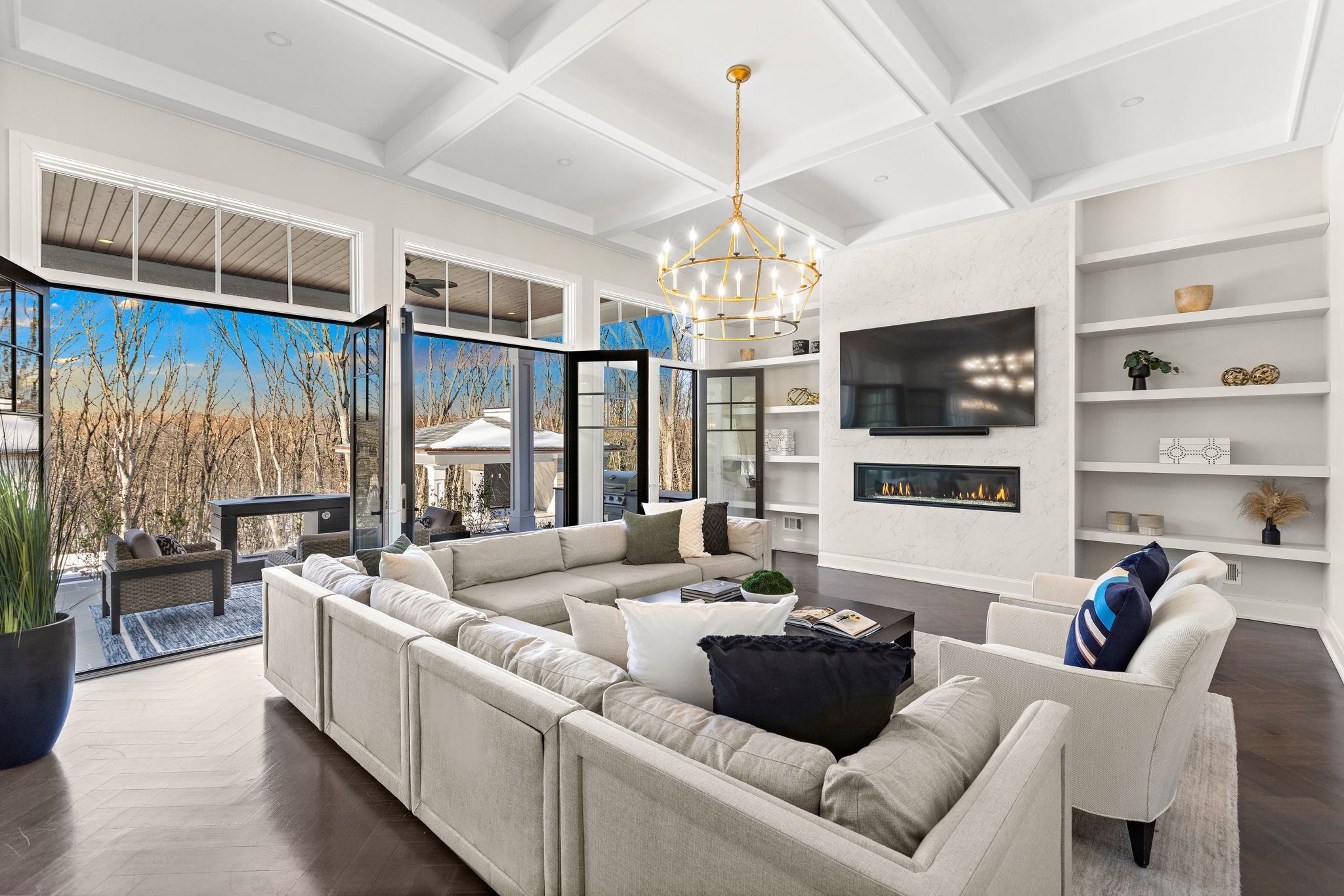 396 Knollwood Road Ridgewood, NJ 07450 - Photo 16 of 50 a living room with furniture a flat screen tv and a chandelier