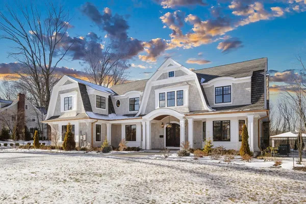 a front view of a building with a yard