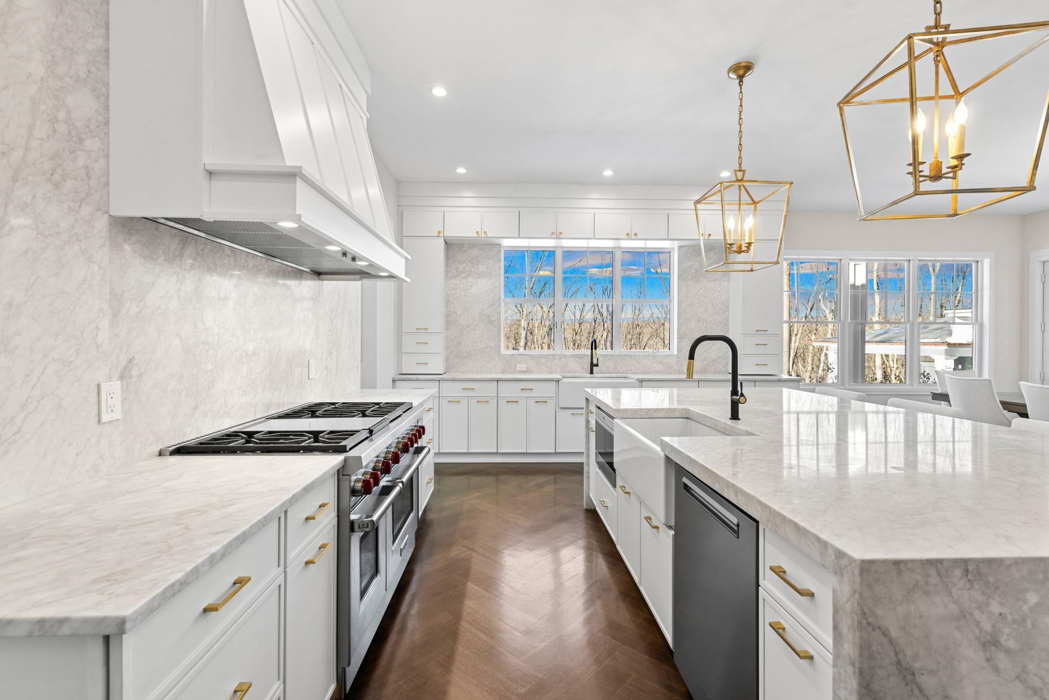 396 Knollwood Road Ridgewood, NJ 07450 - Photo 22 of 50 a kitchen with stainless steel appliances granite countertop a sink a stove and a wooden floors