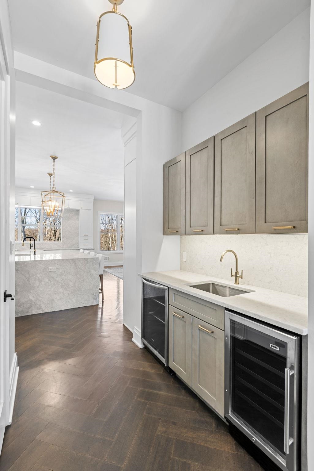 396 Knollwood Road Ridgewood, NJ 07450 - Photo 23 of 50 a kitchen with stainless steel appliances granite countertop a sink and cabinets with wooden floor