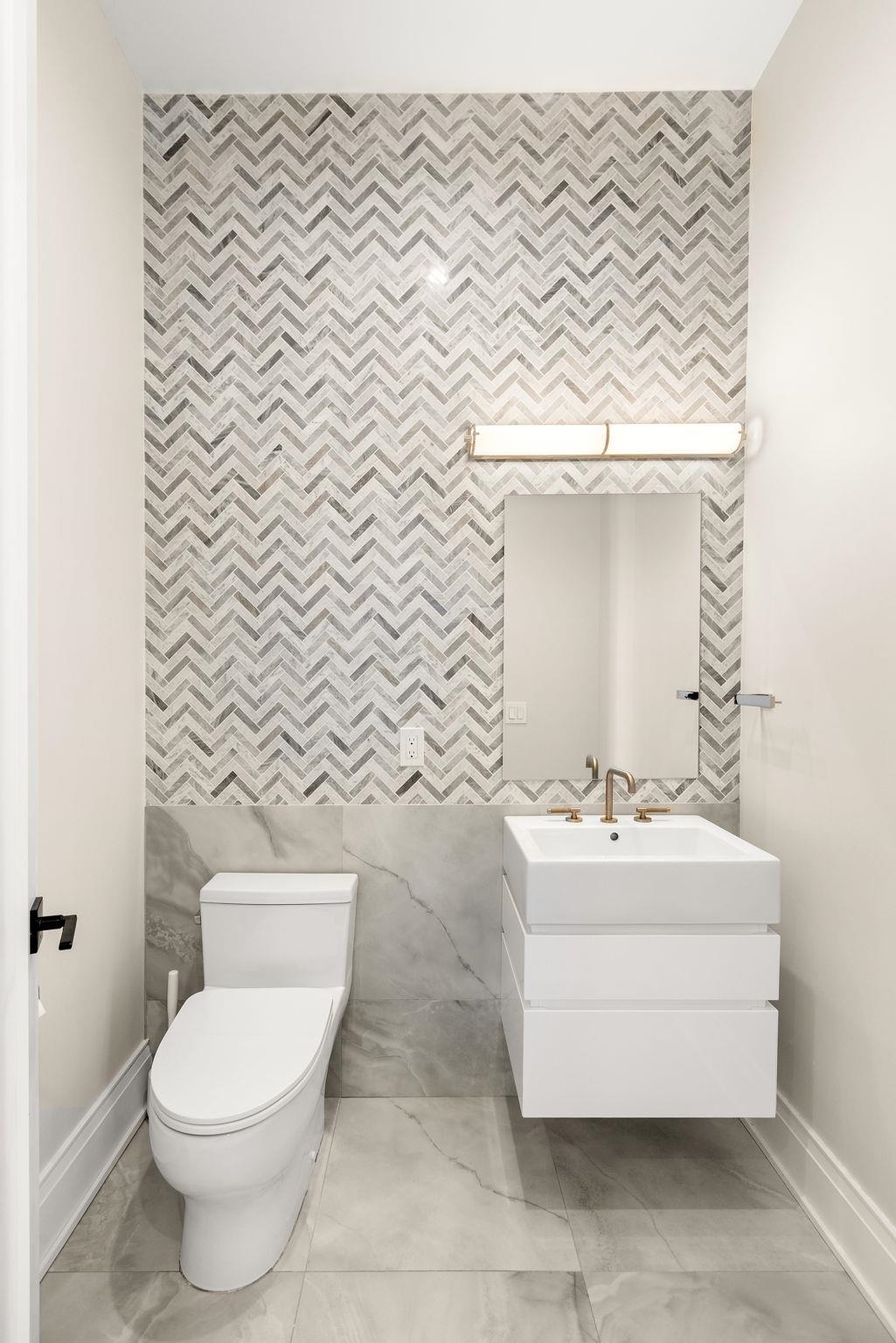 396 Knollwood Road Ridgewood, NJ 07450 - Photo 25 of 50 a bathroom with a sink a toilet and mirror