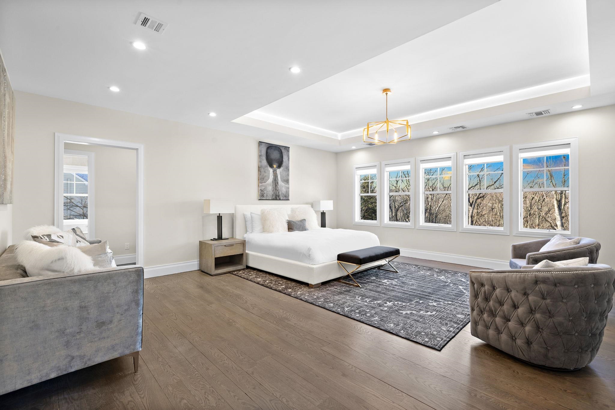 396 Knollwood Road Ridgewood, NJ 07450 - Photo 29 of 50 a spacious bedroom with a bed and a couch