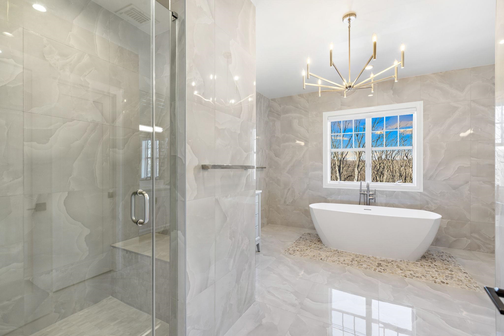 396 Knollwood Road Ridgewood, NJ 07450 - Photo 32 of 50 a spacious bathroom with a bathtub and shower