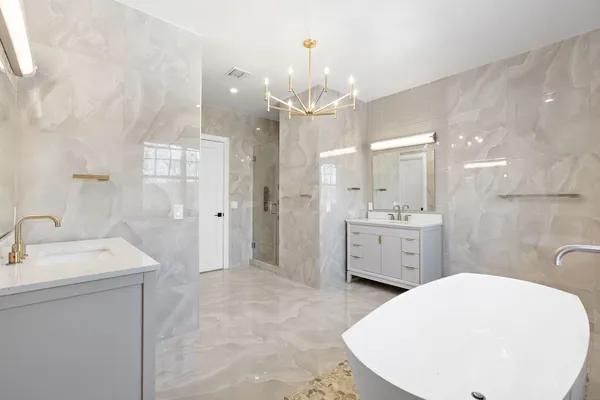 a bedroom with a large bed couch and a window